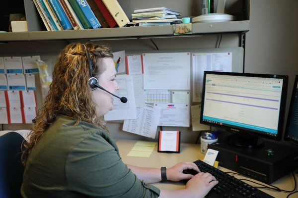 Image of person at a desk typing on a computer