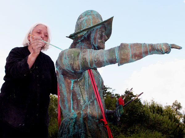 Woman painting a statue