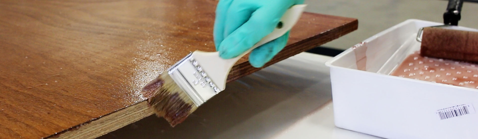 Coating being applied to wood