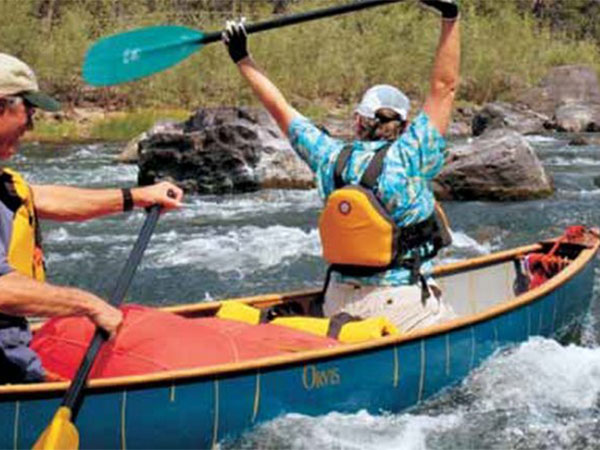 kaykers paddling on a river
