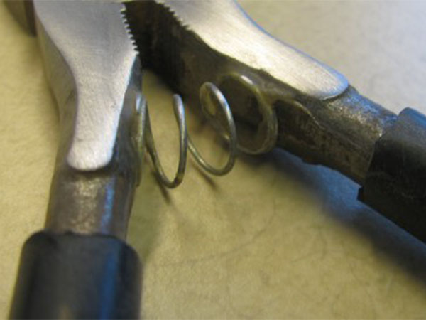 Pliers with a spring added