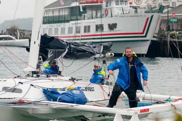 Person steers sailing boat